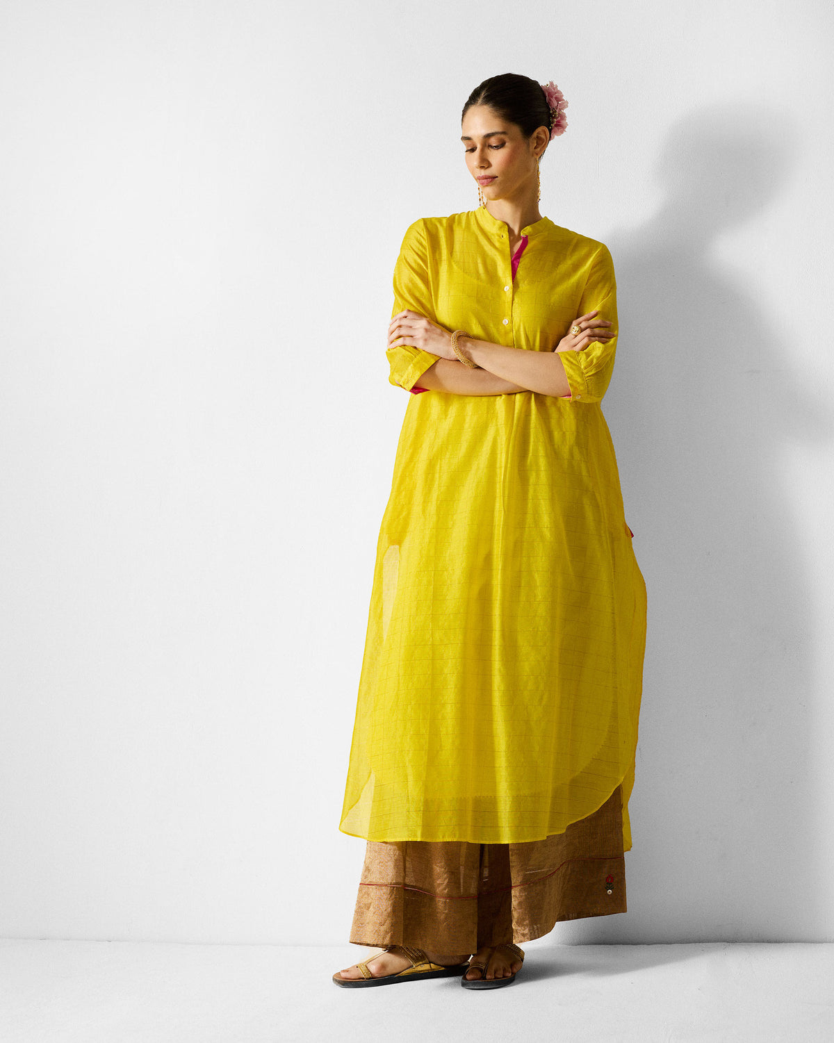 Person wearing a lime and gold checked Kumaon Kurta with pink lining accents.