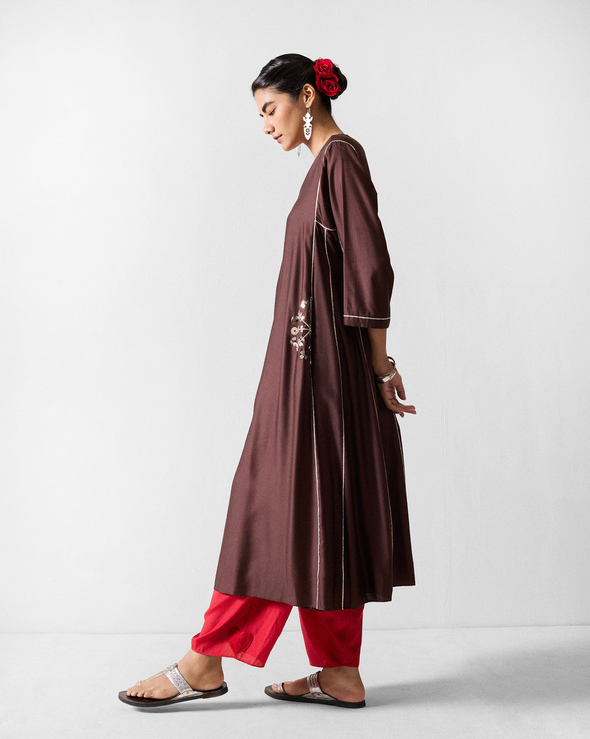 Side view of a chocolate brown Aheli kurta with floral embroidery at the hip.