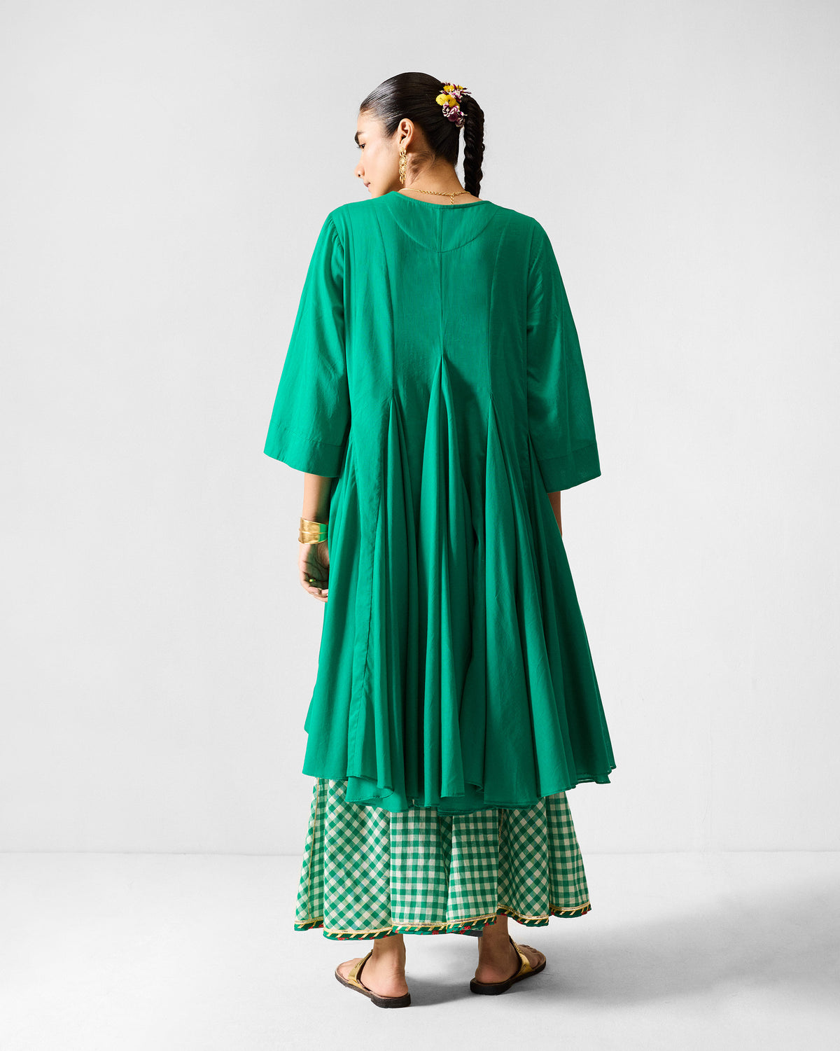Back of a green Gusset Long Kurta with deep vertical pleats.