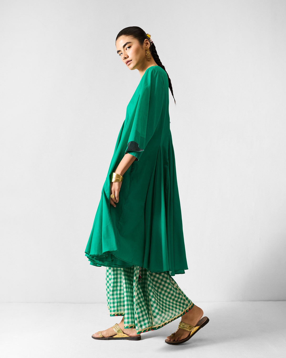 Side view of a green Gusset Long Kurta with a flared hem.