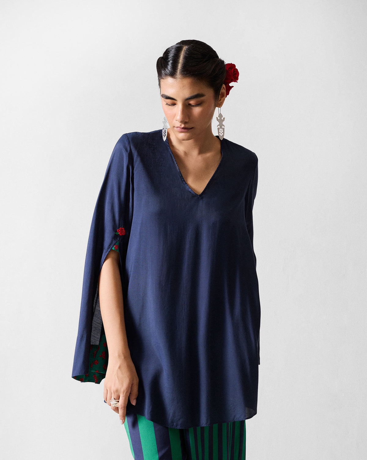 Person wearing a dark navy Panaji Top with green floral sleeve lining.