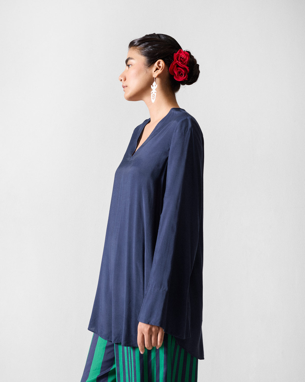 Side view of a dark navy Panaji Top with a V-neck.