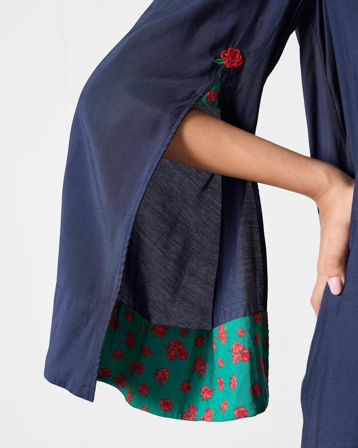 Close-up of the split sleeve and green floral lining on a dark navy Panaji Top.