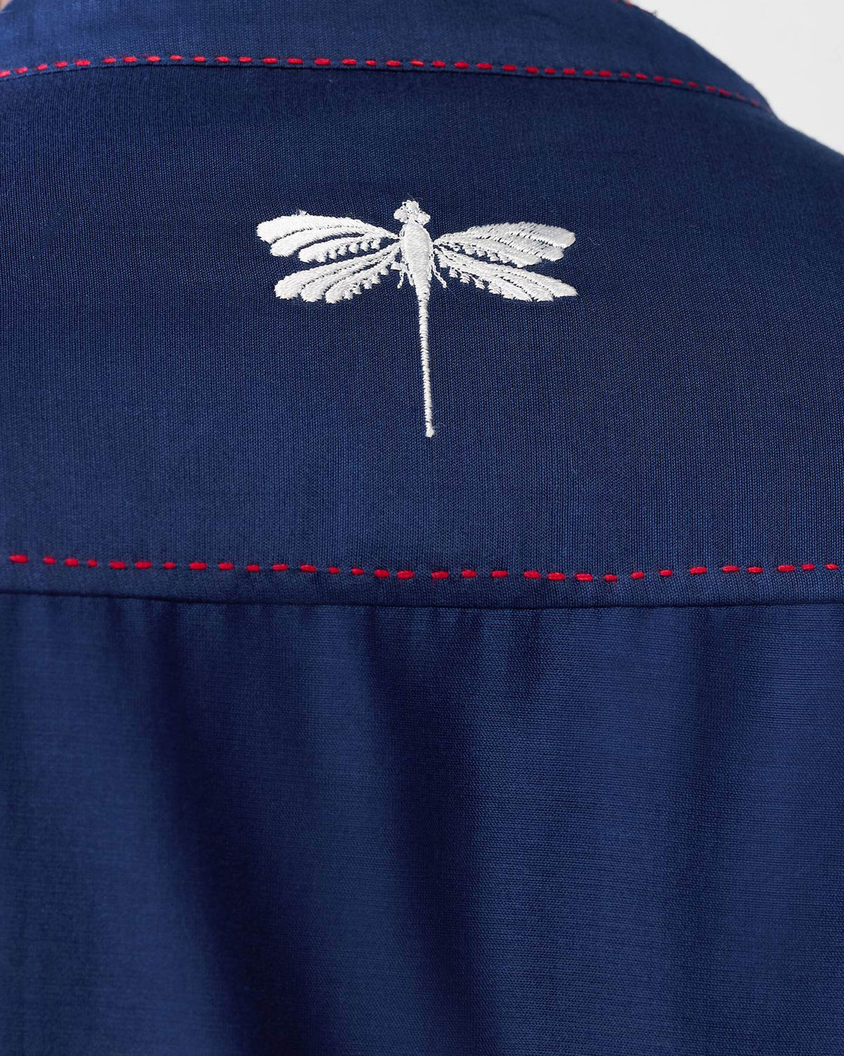 Close-up of a navy Talha kurta showing the white dragonfly on the back.