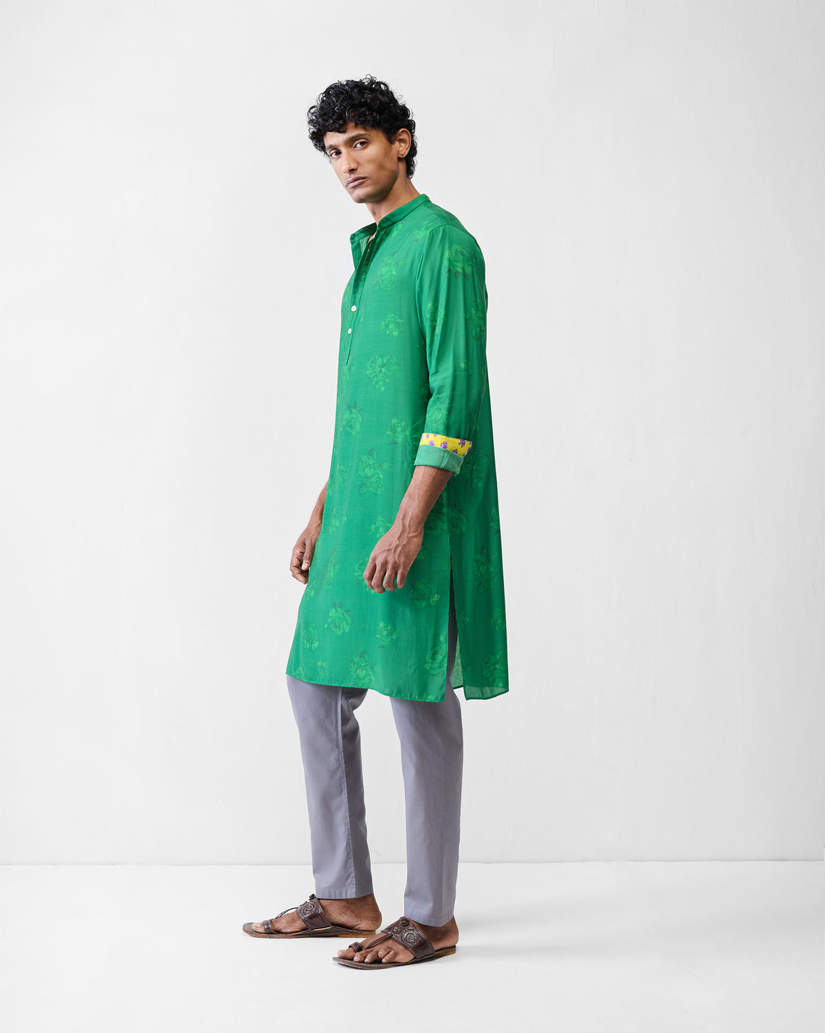 Side view of an emerald green Astral kurta with tonal rose print.