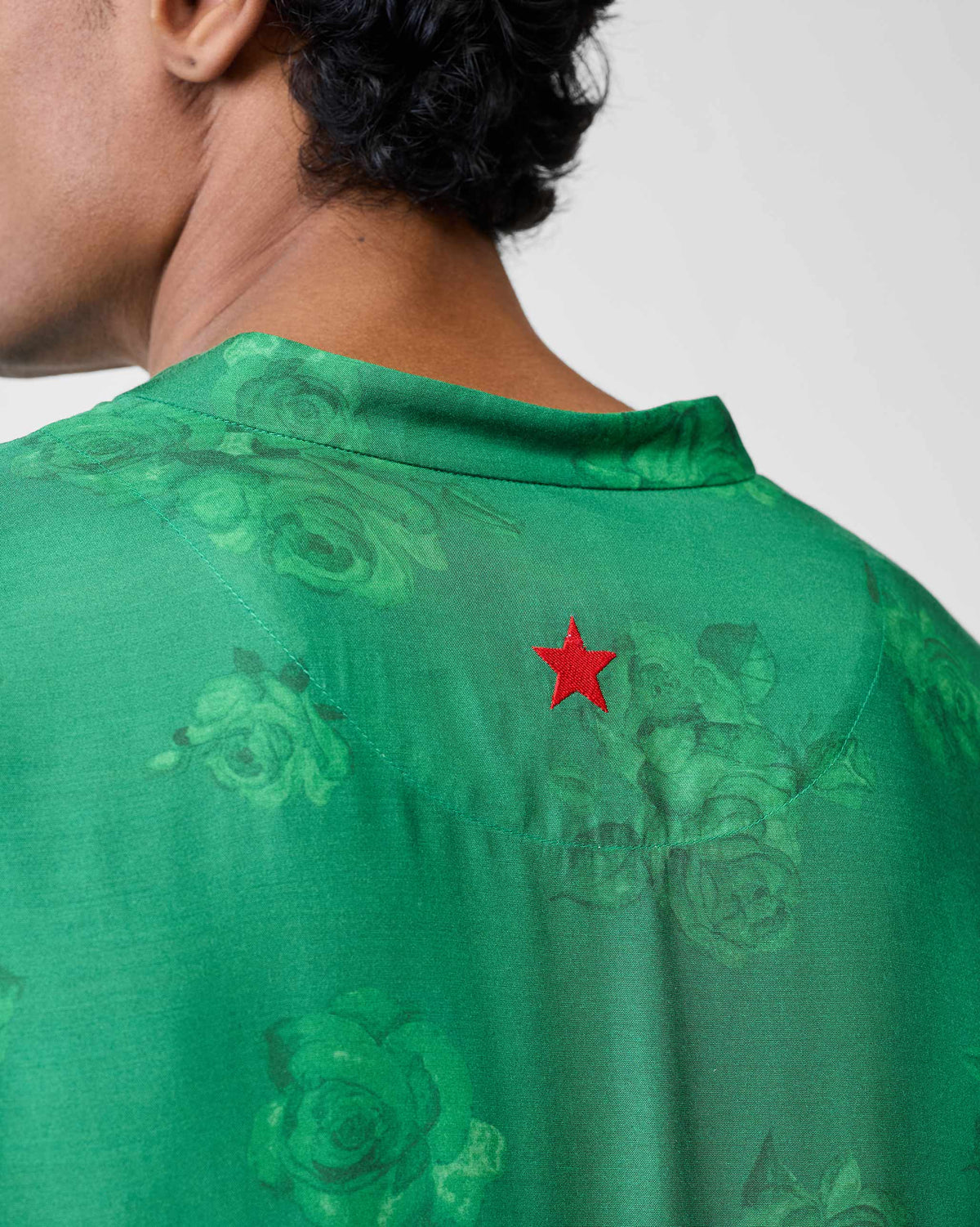 Close-up of emerald Astral kurta back with a red embroidered star.
