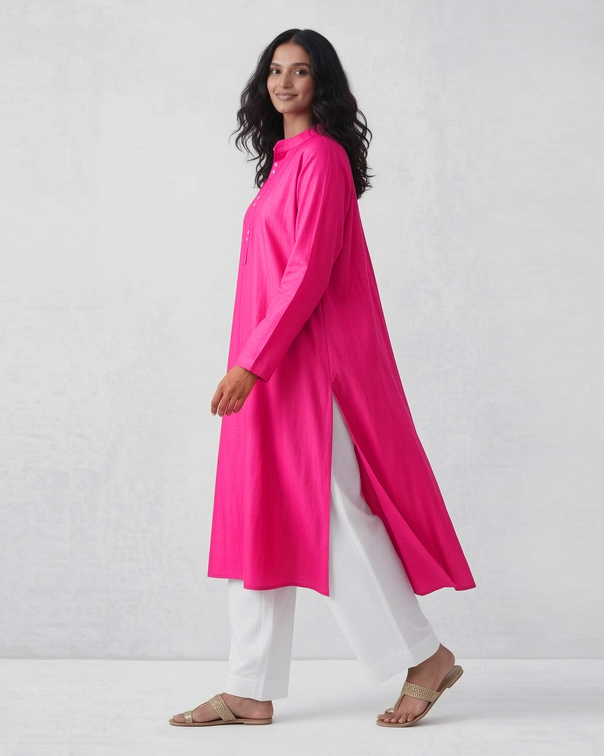 Side view of a fuchsia Long pleated kurta with long side slits.