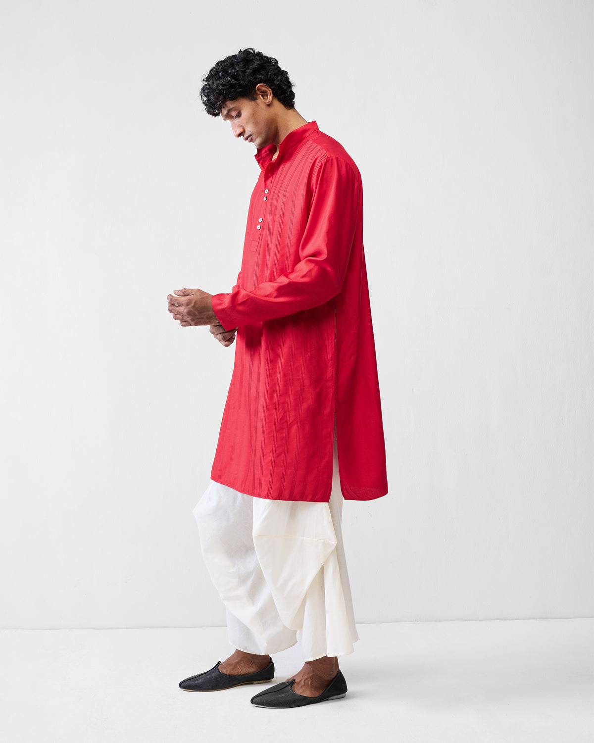 Side view of a red Long Pleated Kurta worn by a person.