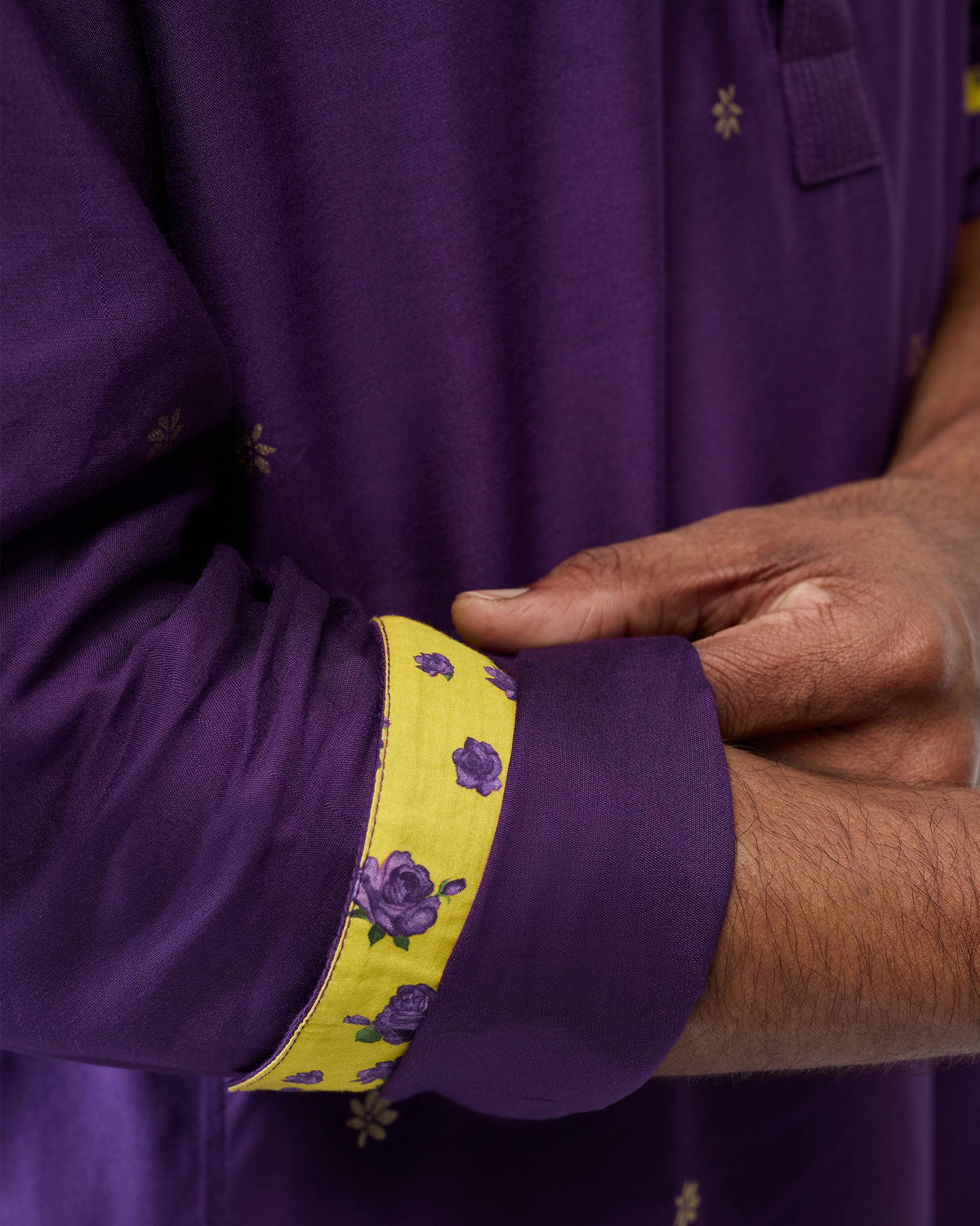 Close-up of a purple Neckband Kurta cuff with yellow floral lining.