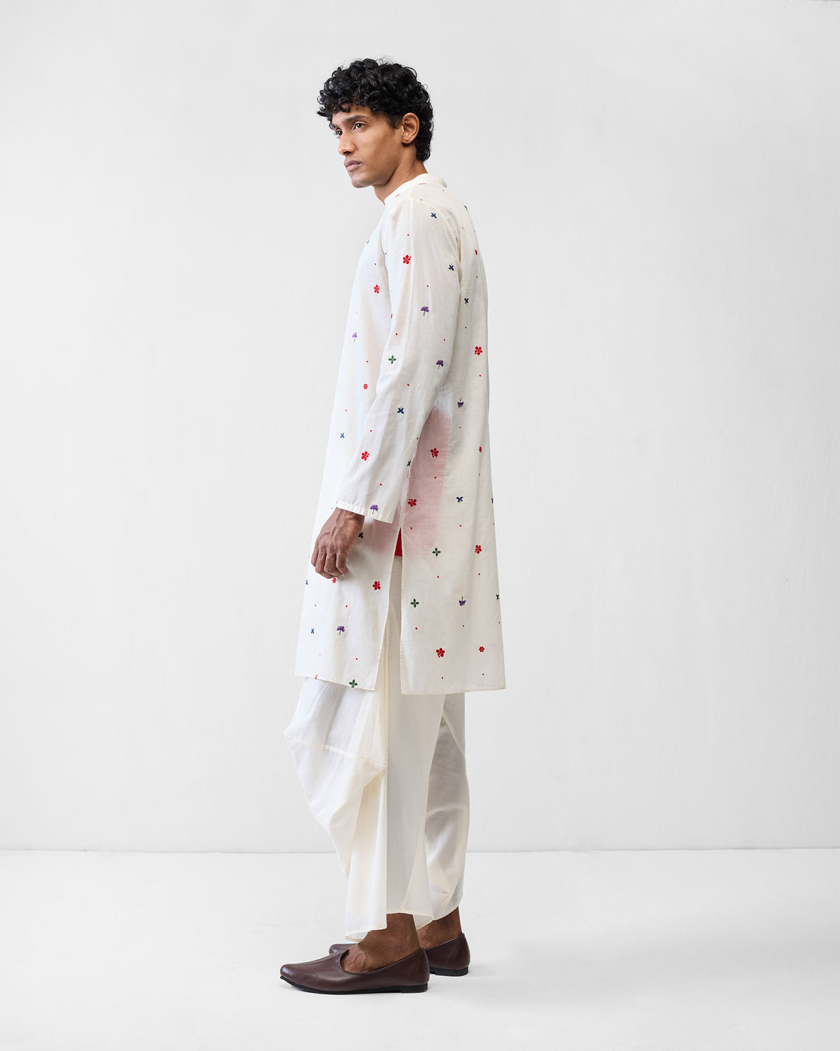 Side view of an ivory Zenith Kurta with colourful embroidered motifs.