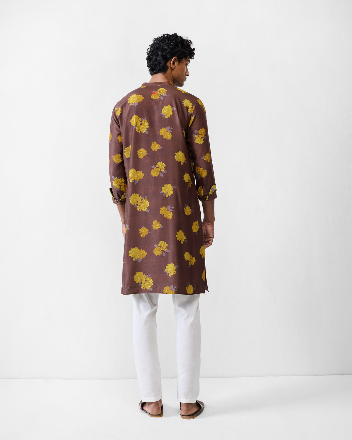 Back of a brown Astral kurta with yellow floral print.