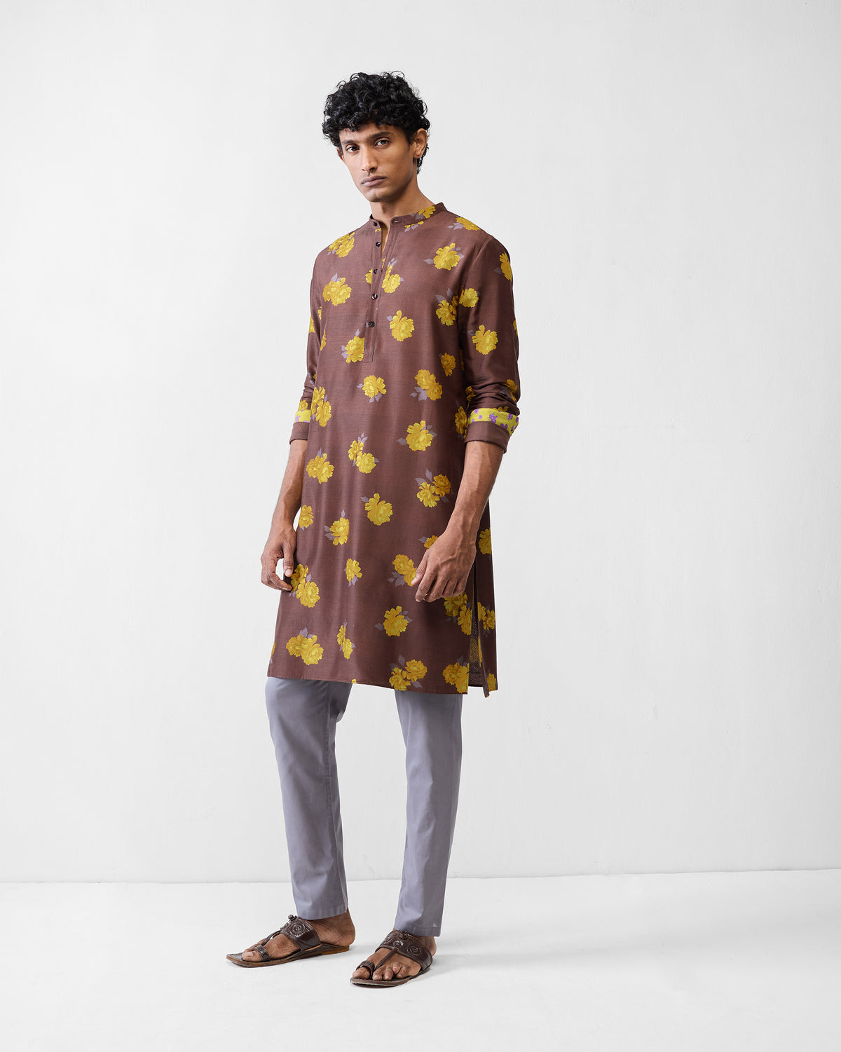 Person wearing a brown Astral kurta with yellow floral print.