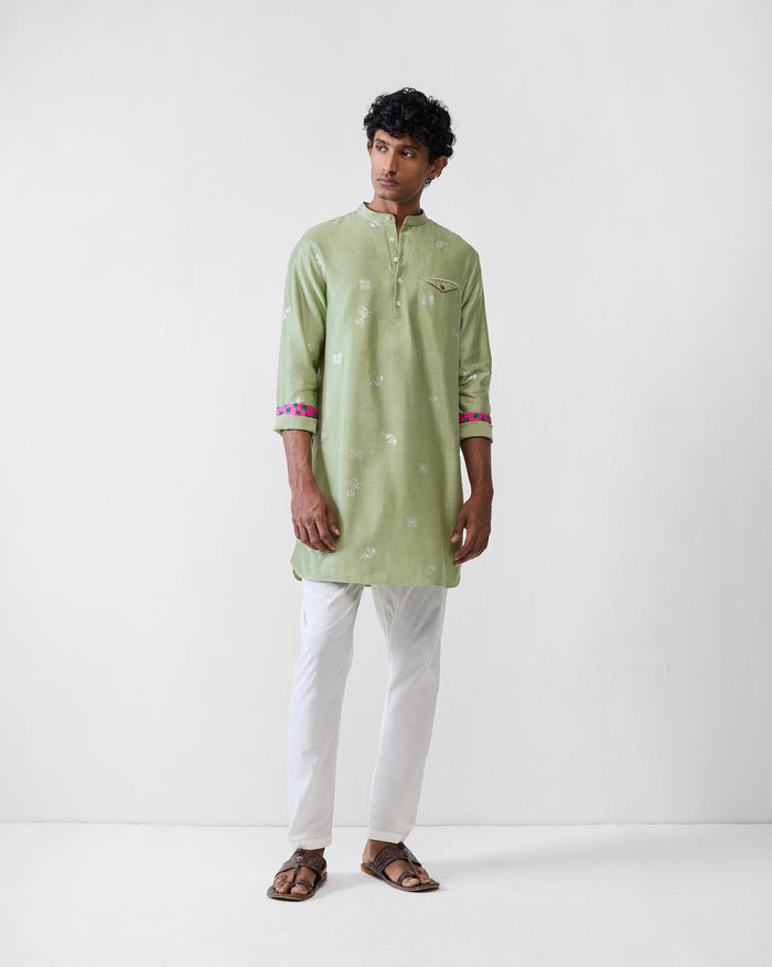 Person wearing a mint Fort kurta with white motifs and contrast cuff lining.