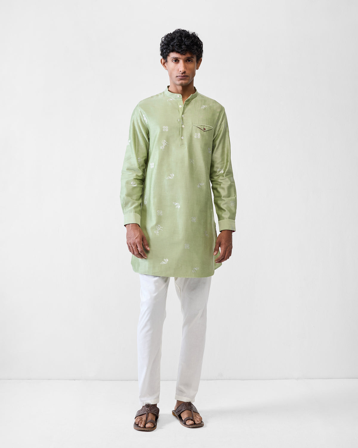 Person wearing a mint Fort kurta with white motifs over white trousers.