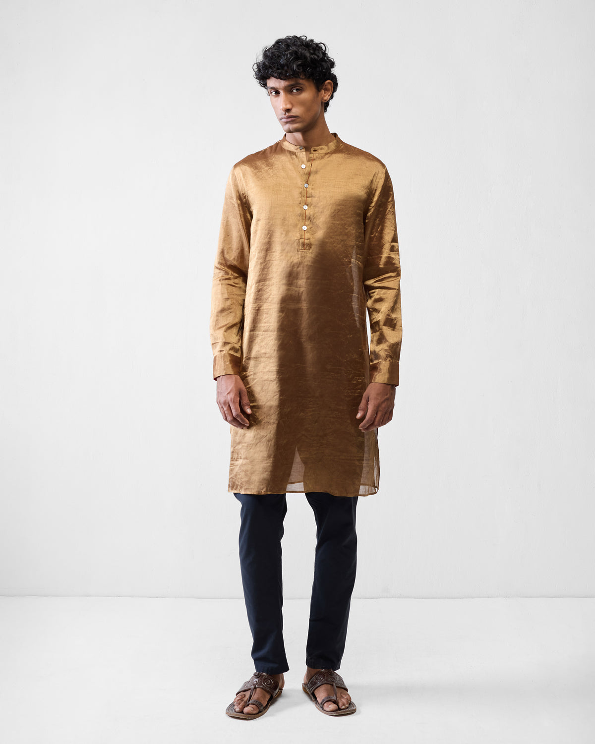 Person wearing a gold Chandni Chowk kurta.