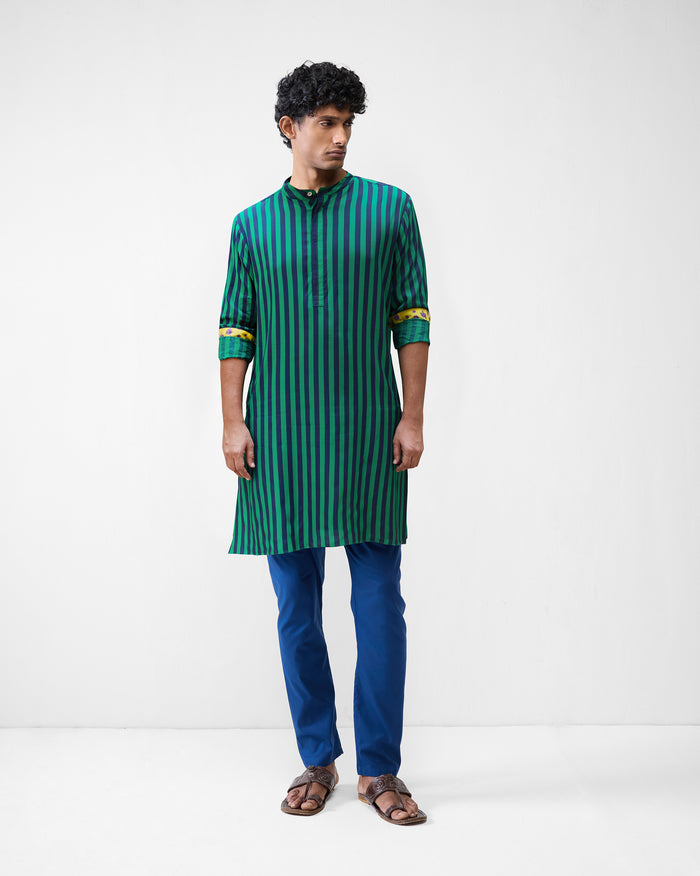 Person wearing a green and navy striped Gala Kurta with yellow cuff lining.