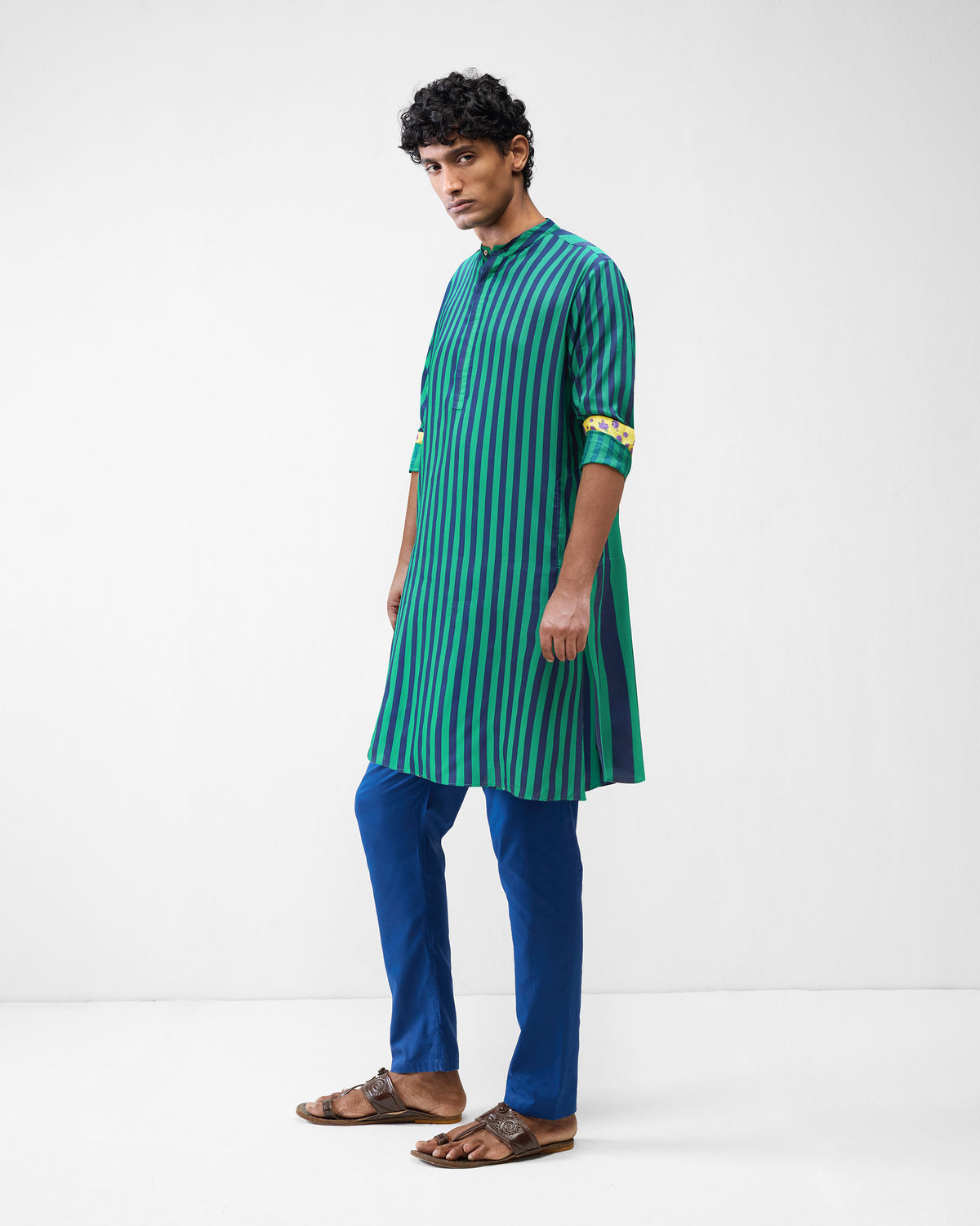 Three-quarter view of a green and navy striped Gala Kurta with yellow cuffs.