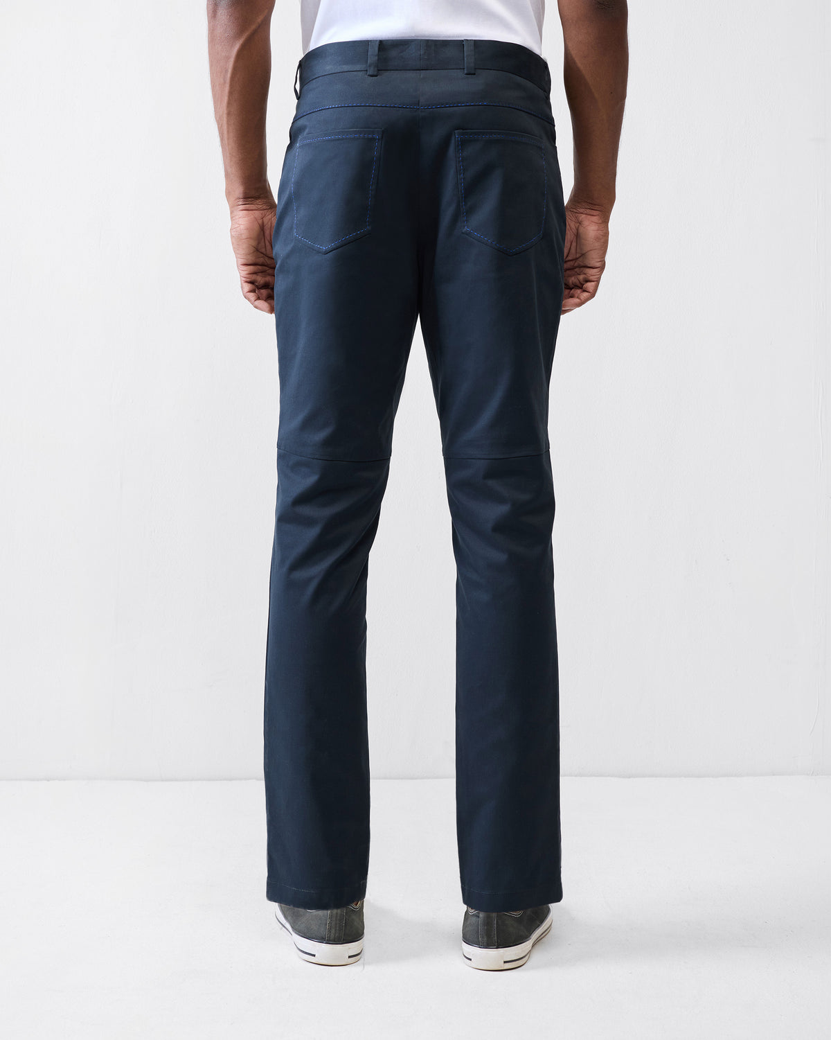 Back of black Viraas pants showing patch pockets and knee seams.