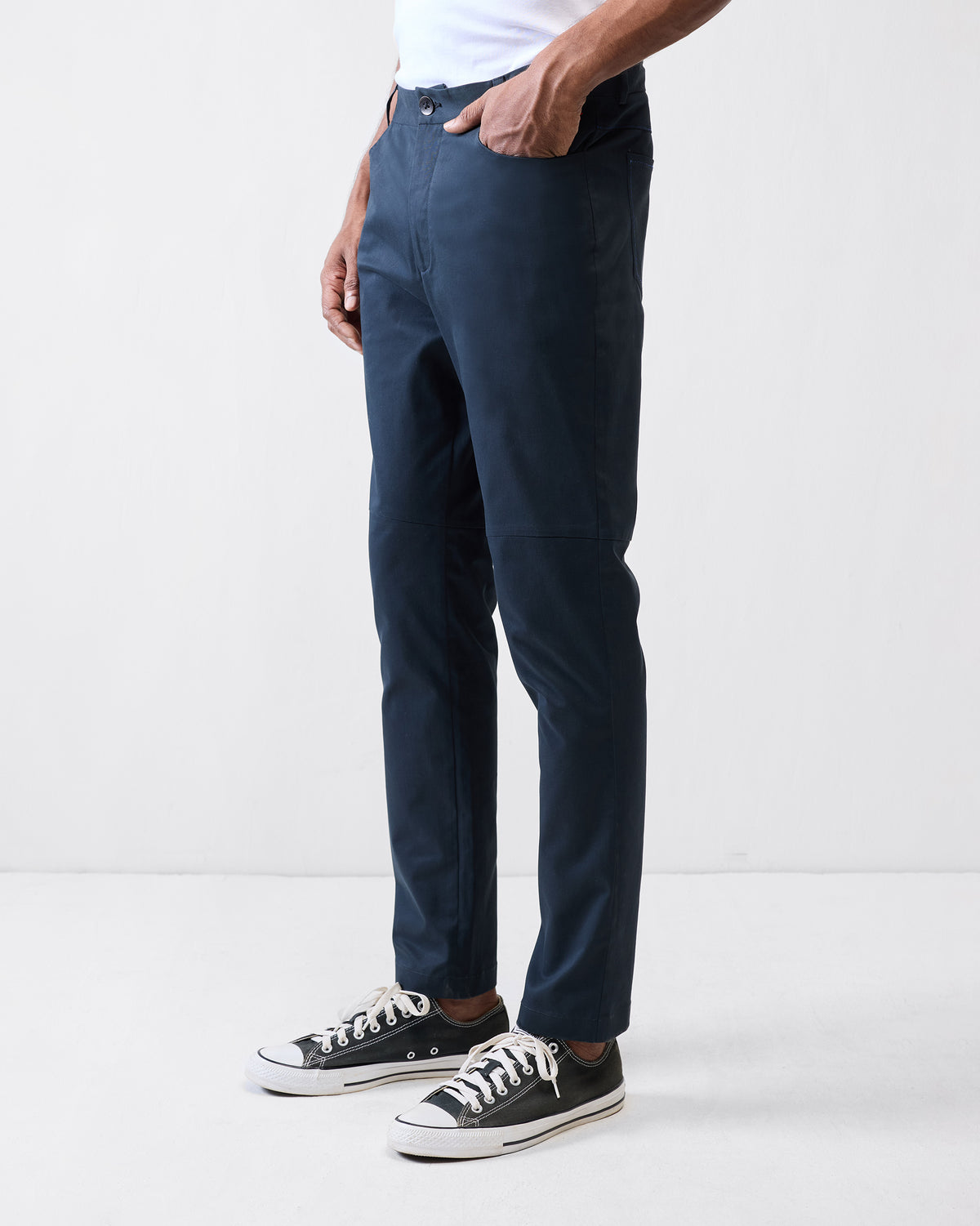Side view of black Viraas pants showing the knee seam detail.
