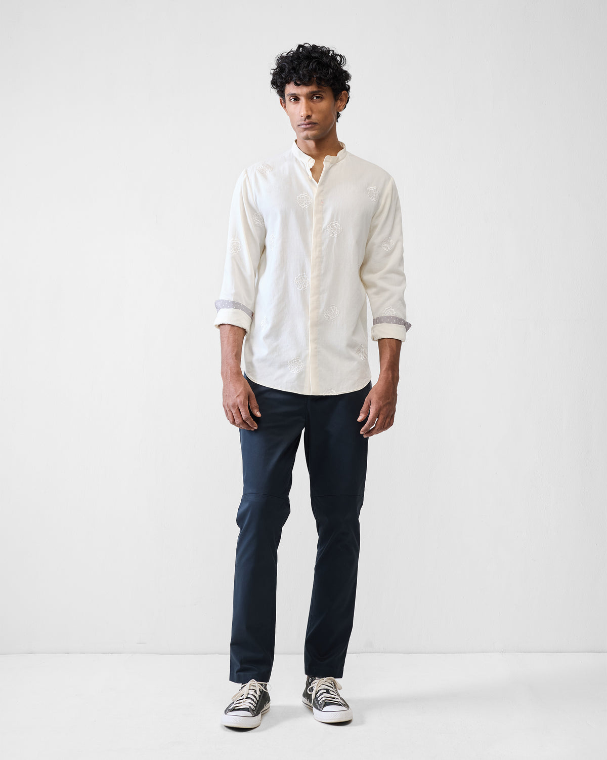Black Viraas pants worn with an ivory kurta in a full outfit.