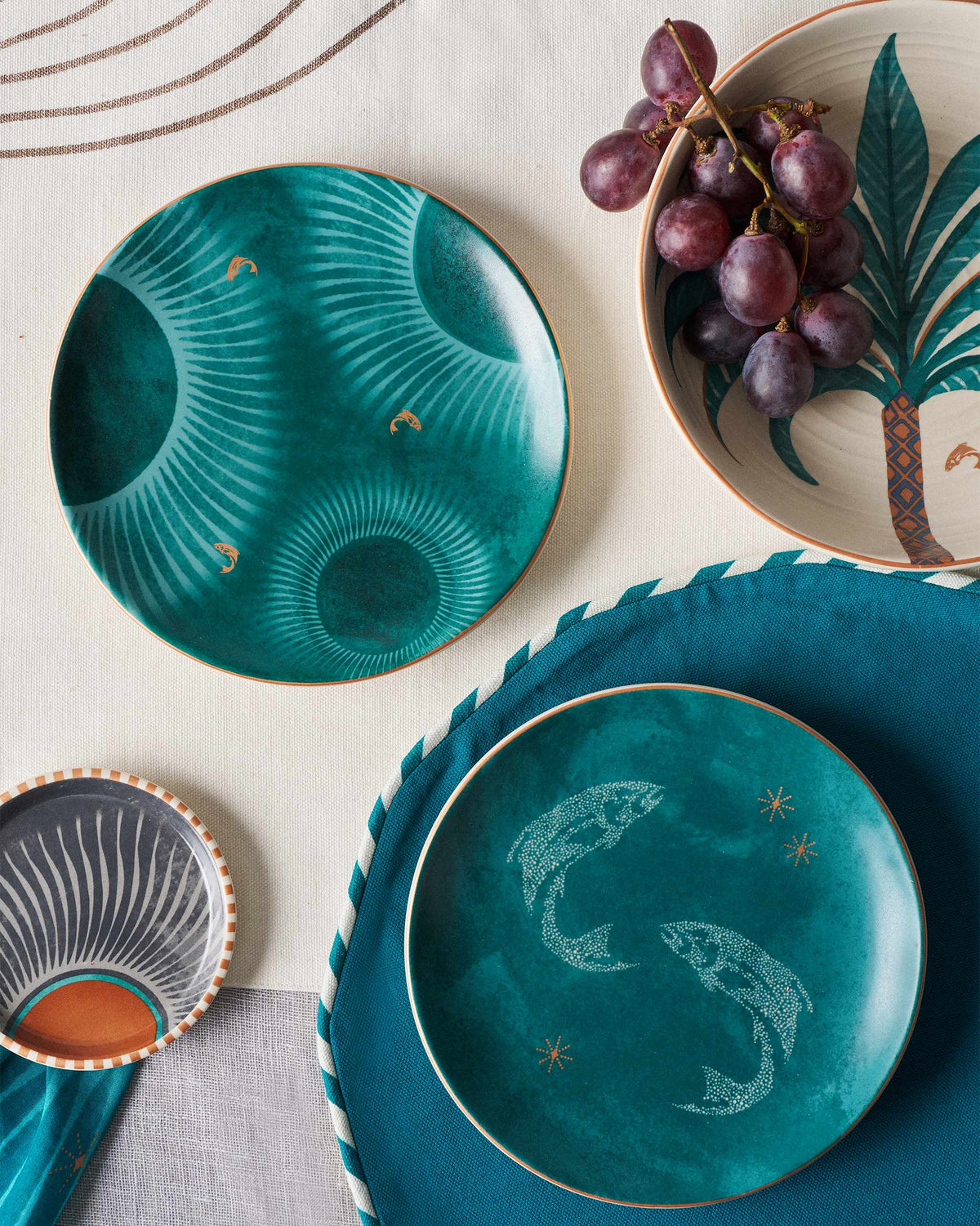 Caden quarter plates styled on a table with grapes and matching pieces.