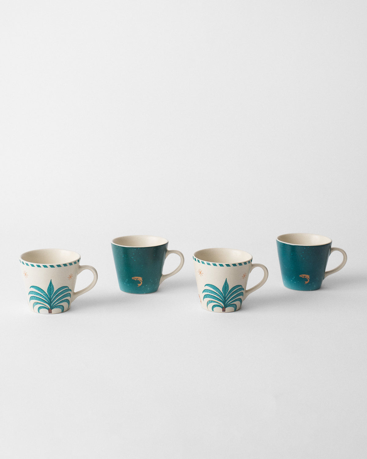 Four Aluna Espresso Mugs lined up with palm-tree and teal fish prints.