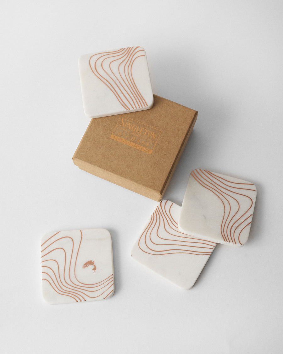 The coasters beside their box.