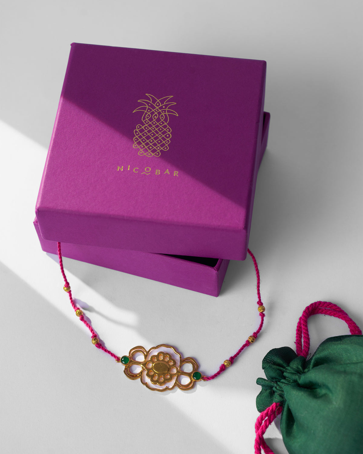 Gold titli choker beside a Nicobar jewellery box.