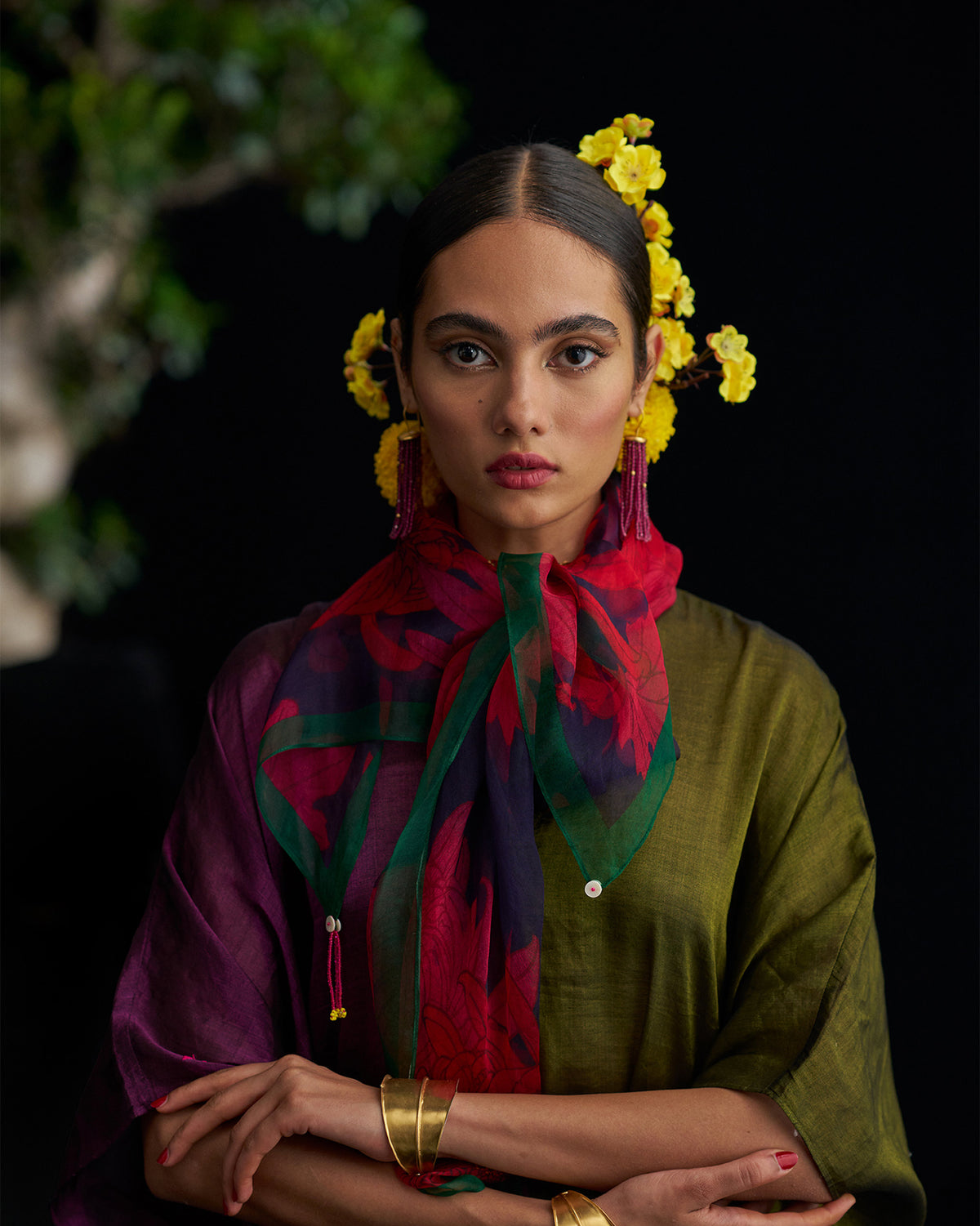 Person wearing the Chrysanthemum Bloom Scarf with a green edge and red bloom print.