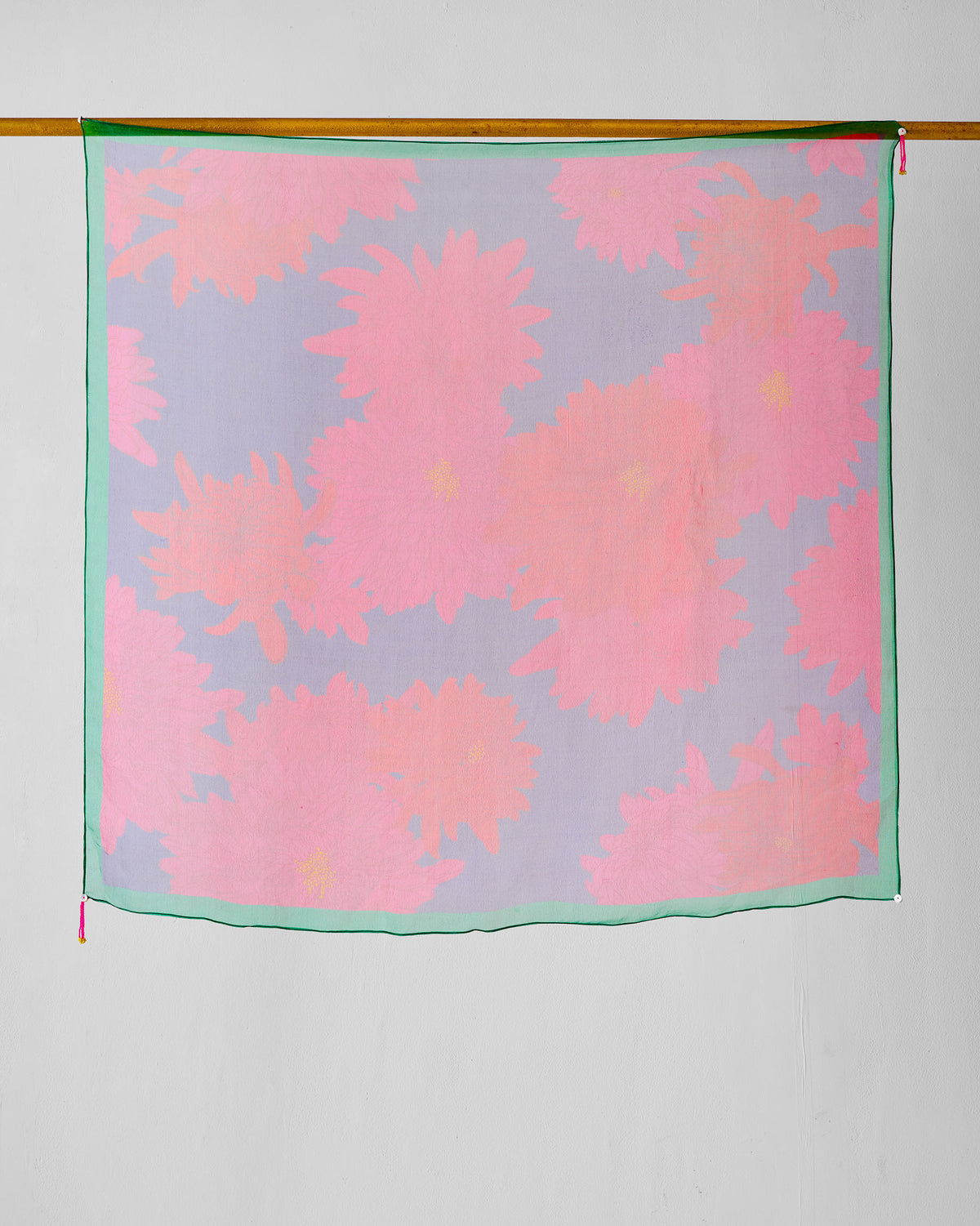 Chrysanthemum Bloom Scarf with pink blooms on lavender, hung from a rod.