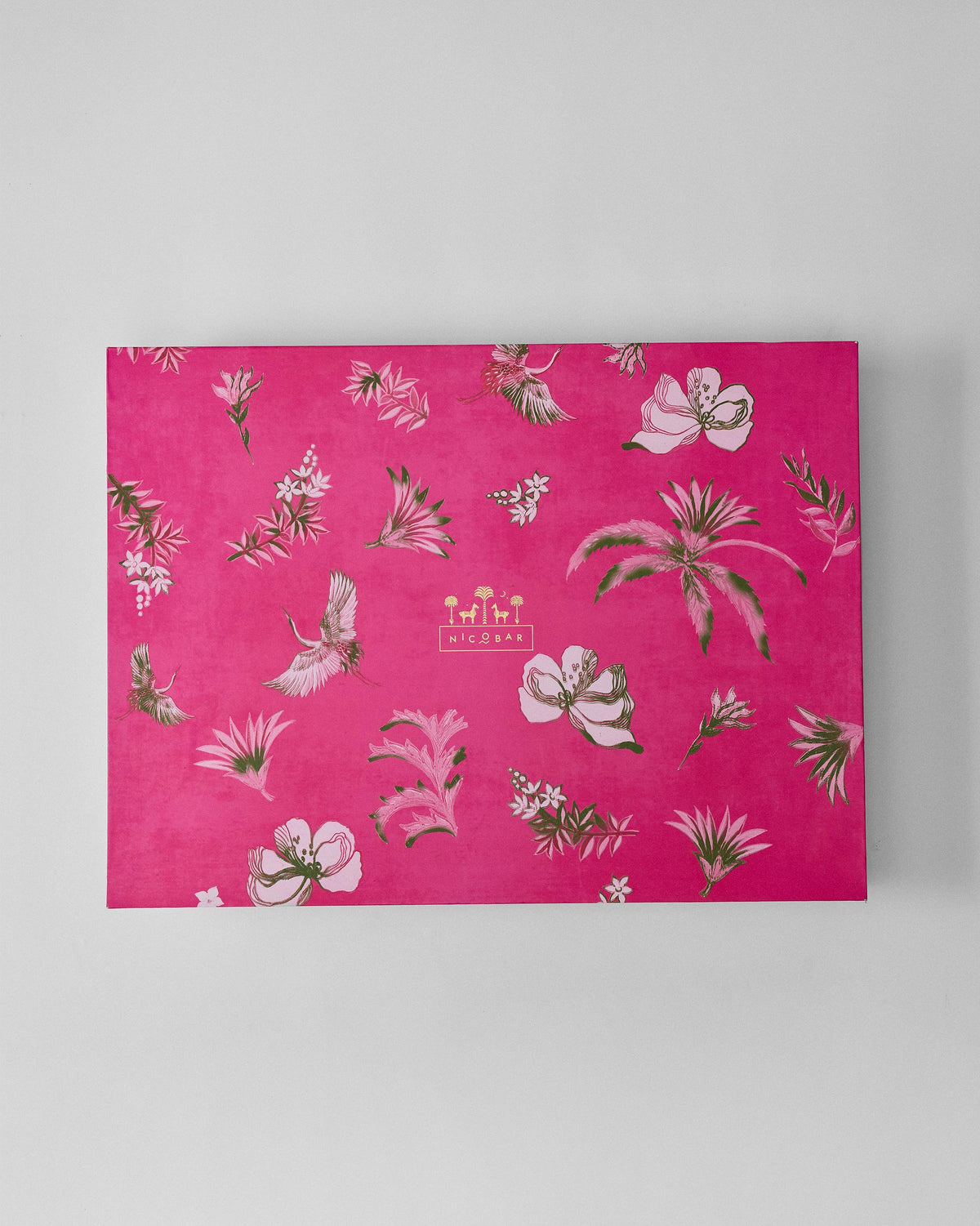 Pink floral lid of the Madhu Dinner Gift Set box with a Nicobar mark.