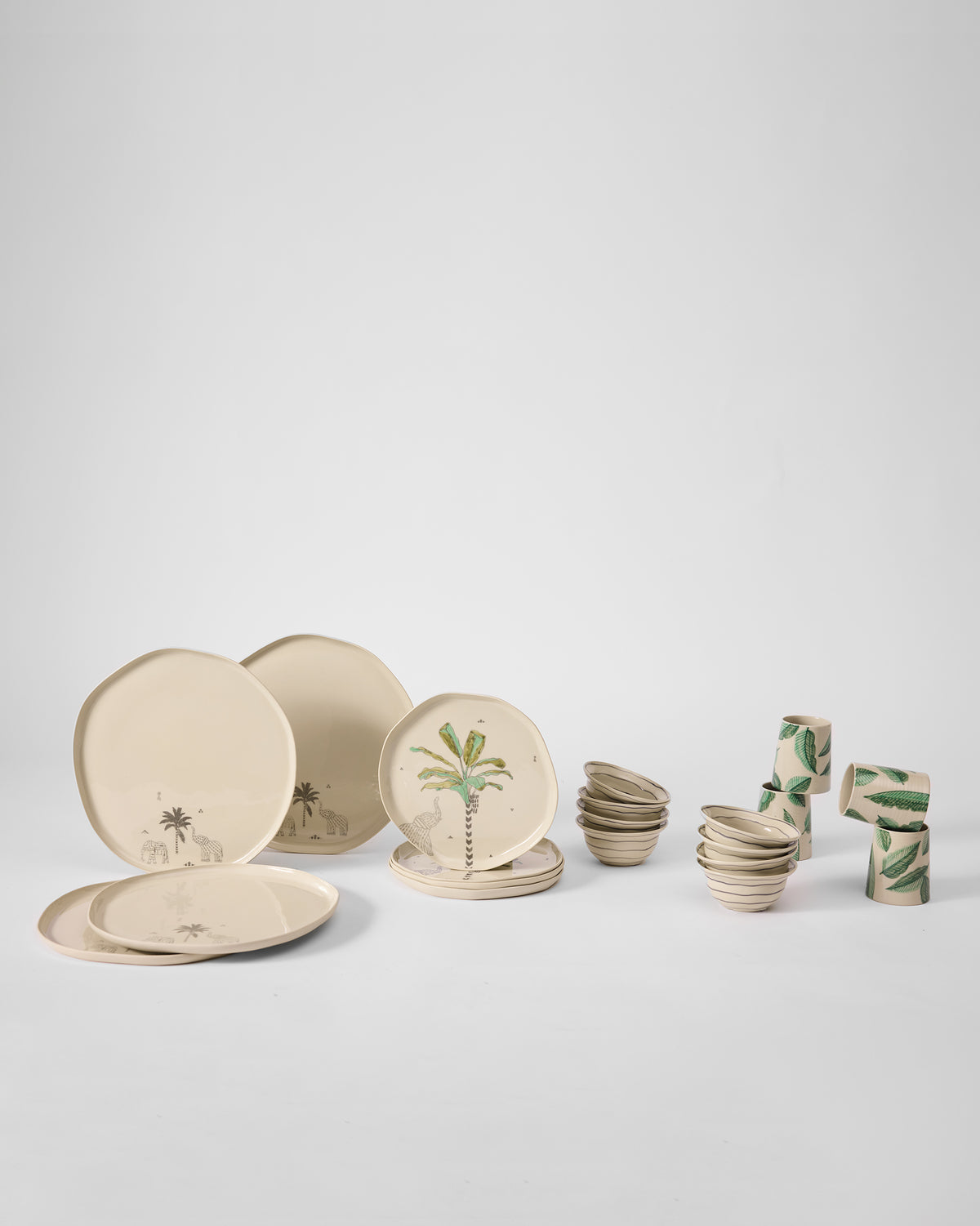 Ceylon Trail Dinner Gift Set laid out, with palm-print plates, bowls and leaf-print cups.