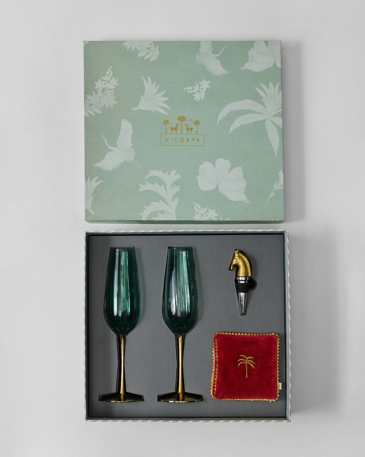 Open Prance gift box with champagne flutes and horse-head stopper.