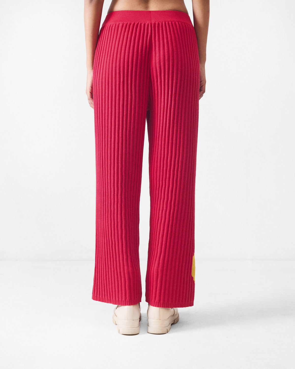 Back of red rib-knit wide-leg pants.