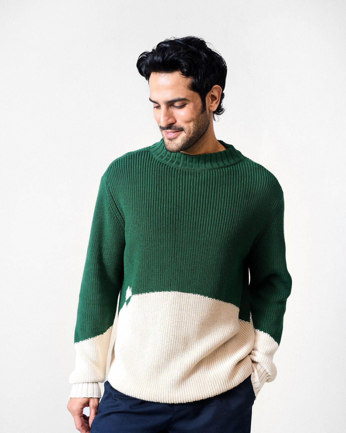 Green and ivory colour-block crew neck sweater with a ribbed knit texture.