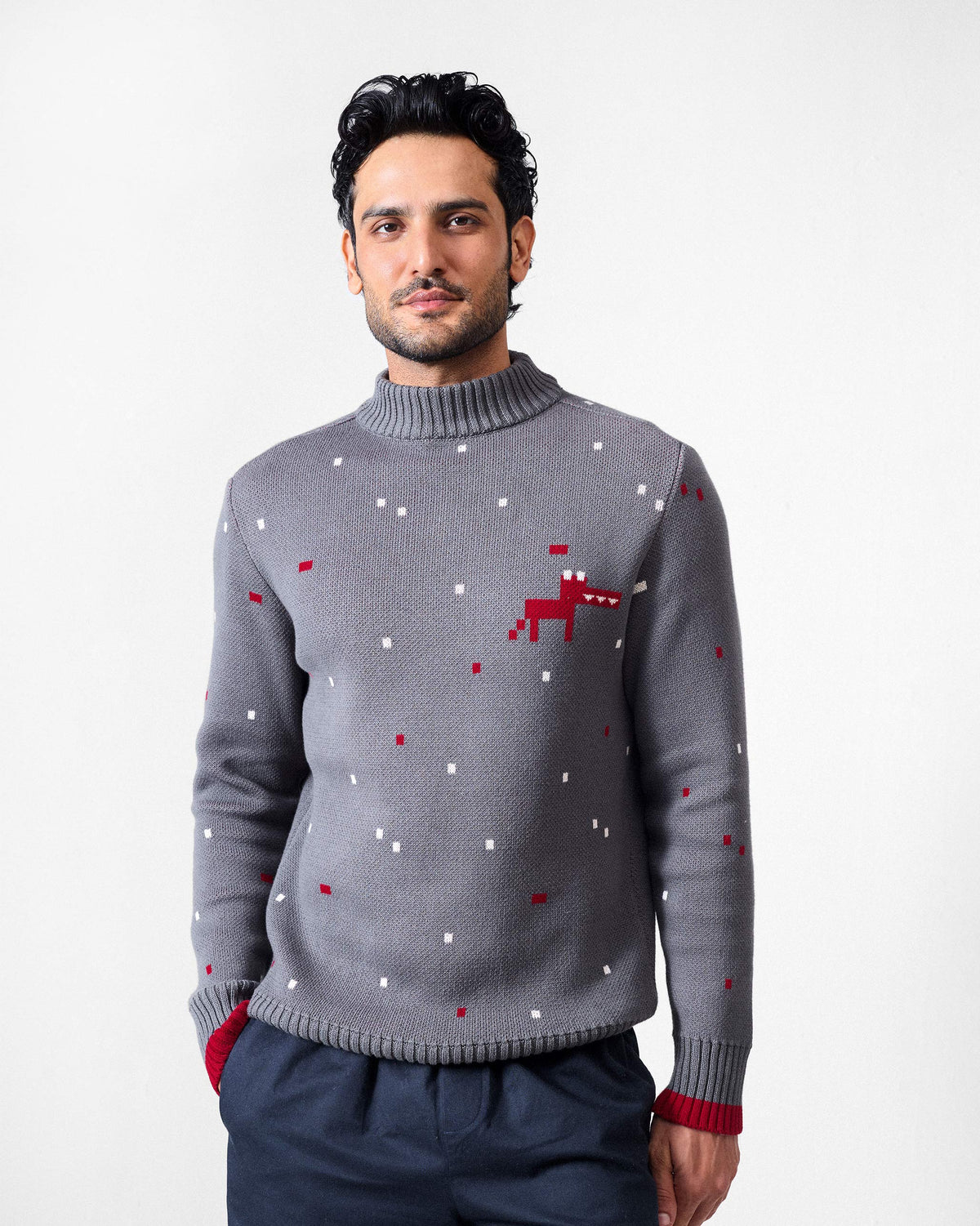 Person wearing a charcoal Crew Neck sweater with a red pixel dino on the chest.