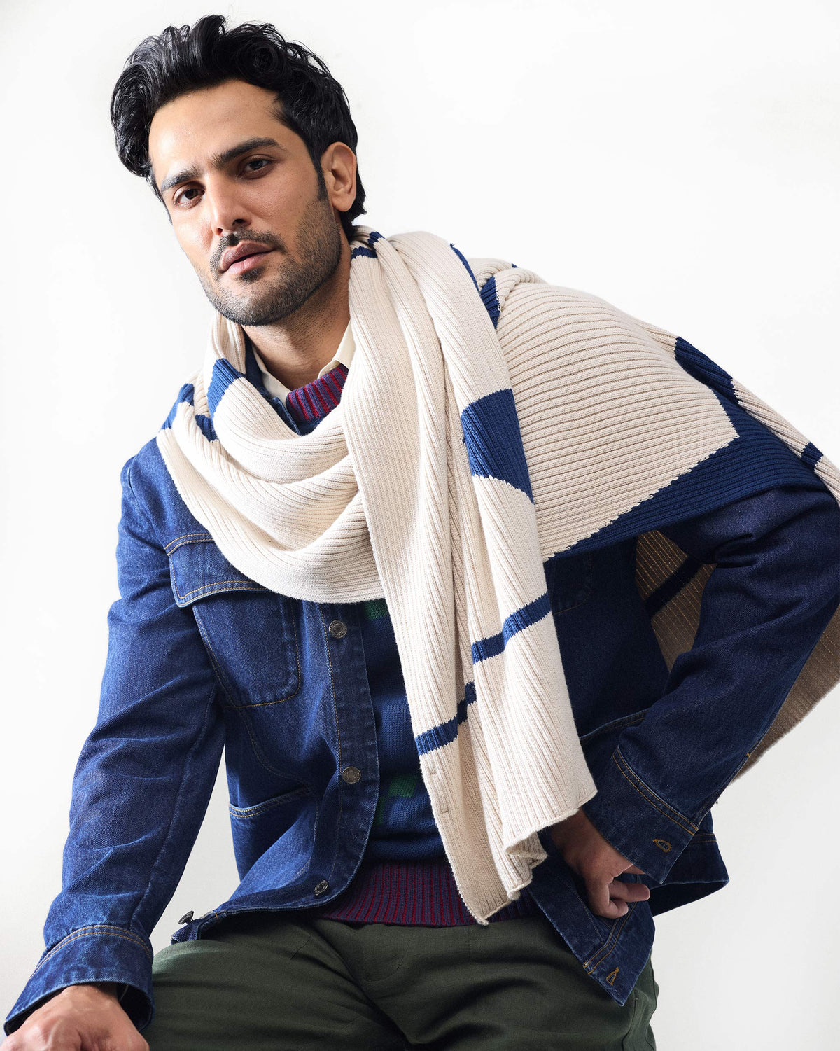 Navy Pixel Sweater layered under a denim jacket with a striped scarf.