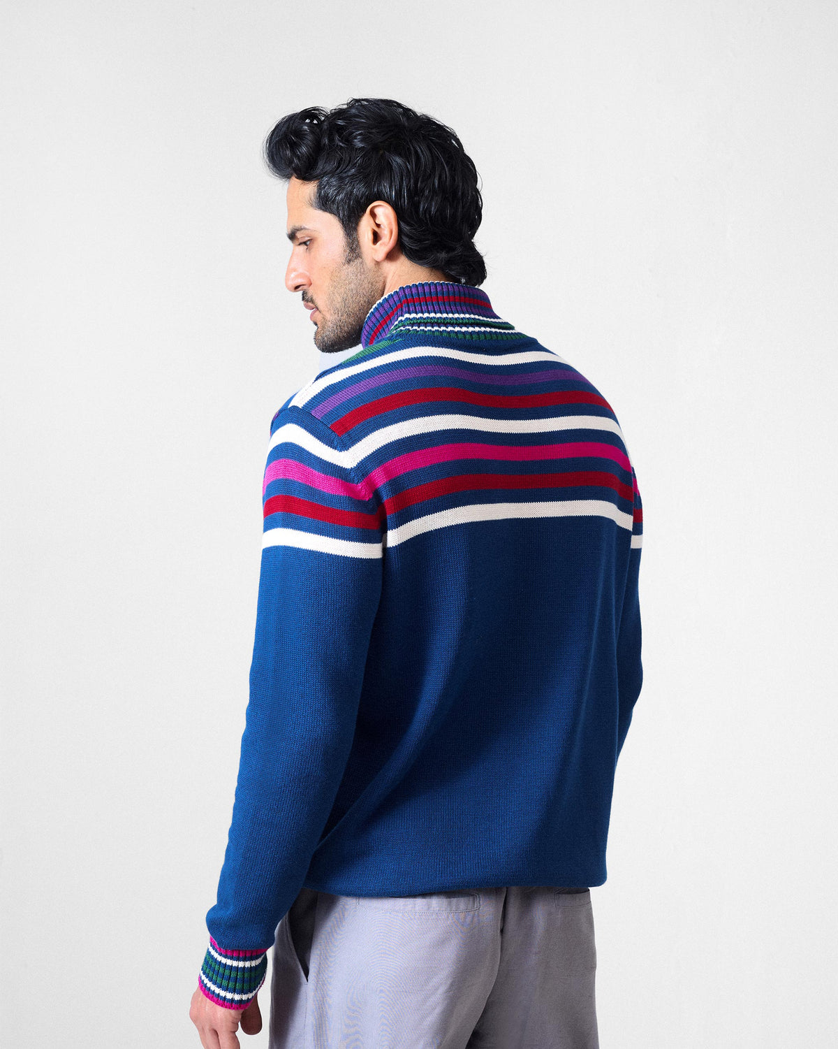 Back of a navy Ringer sweater showing multicolour stripes across the shoulders.