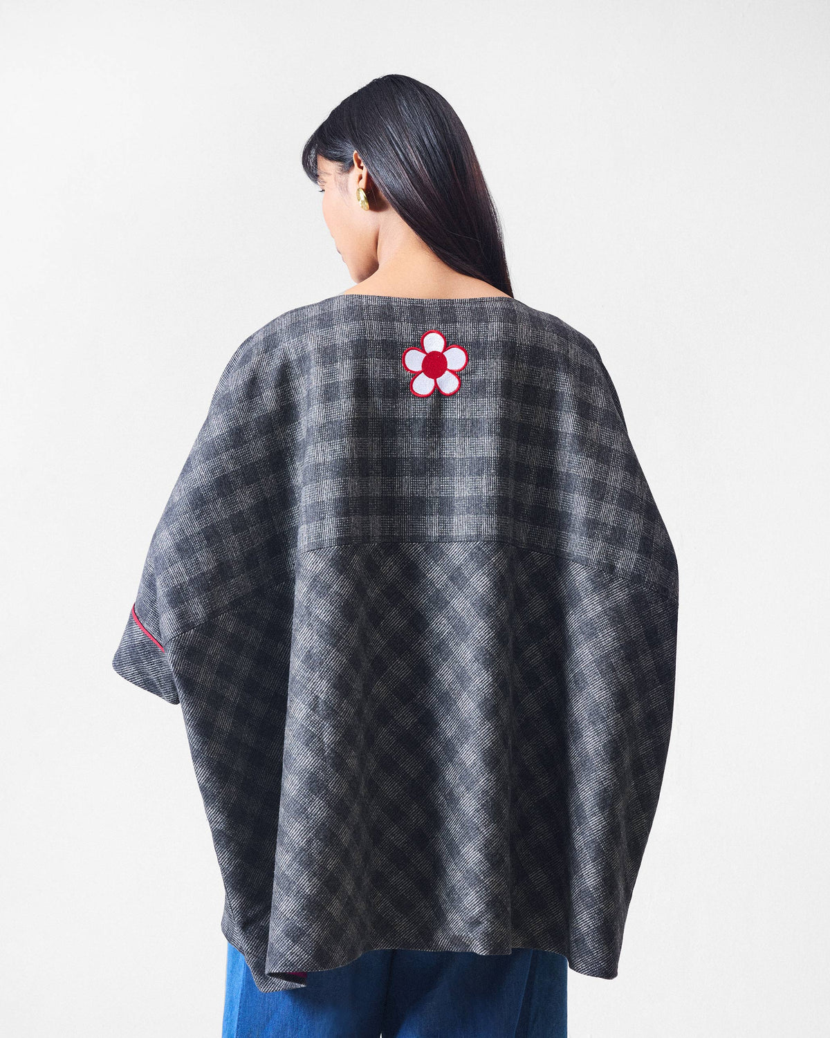 Back of a Fable Top in black and charcoal check with a red and white flower.