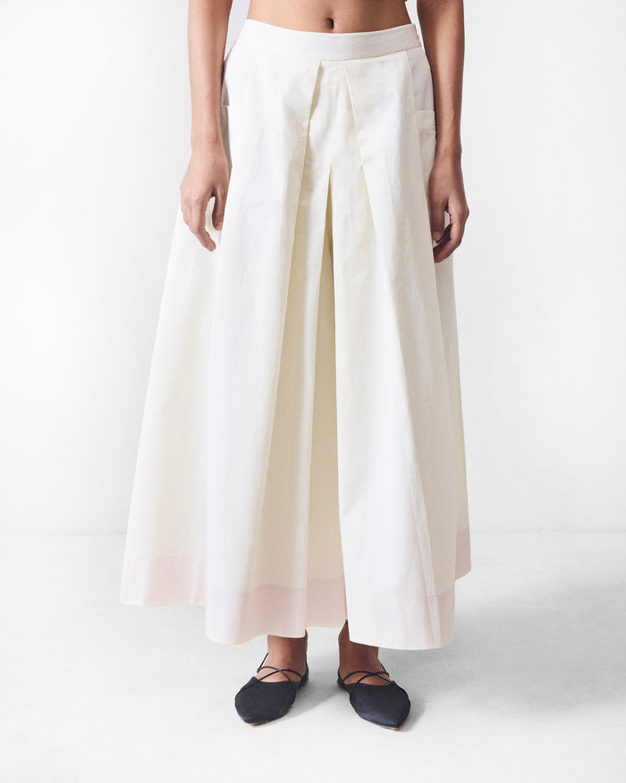 Ivory Twirl skort with deep front pleats and a pale hem band.