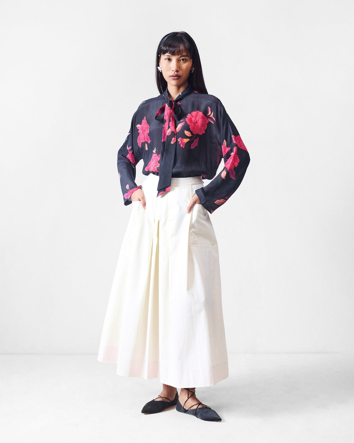 Person wearing an ivory Twirl skort with hands in the side pockets.
