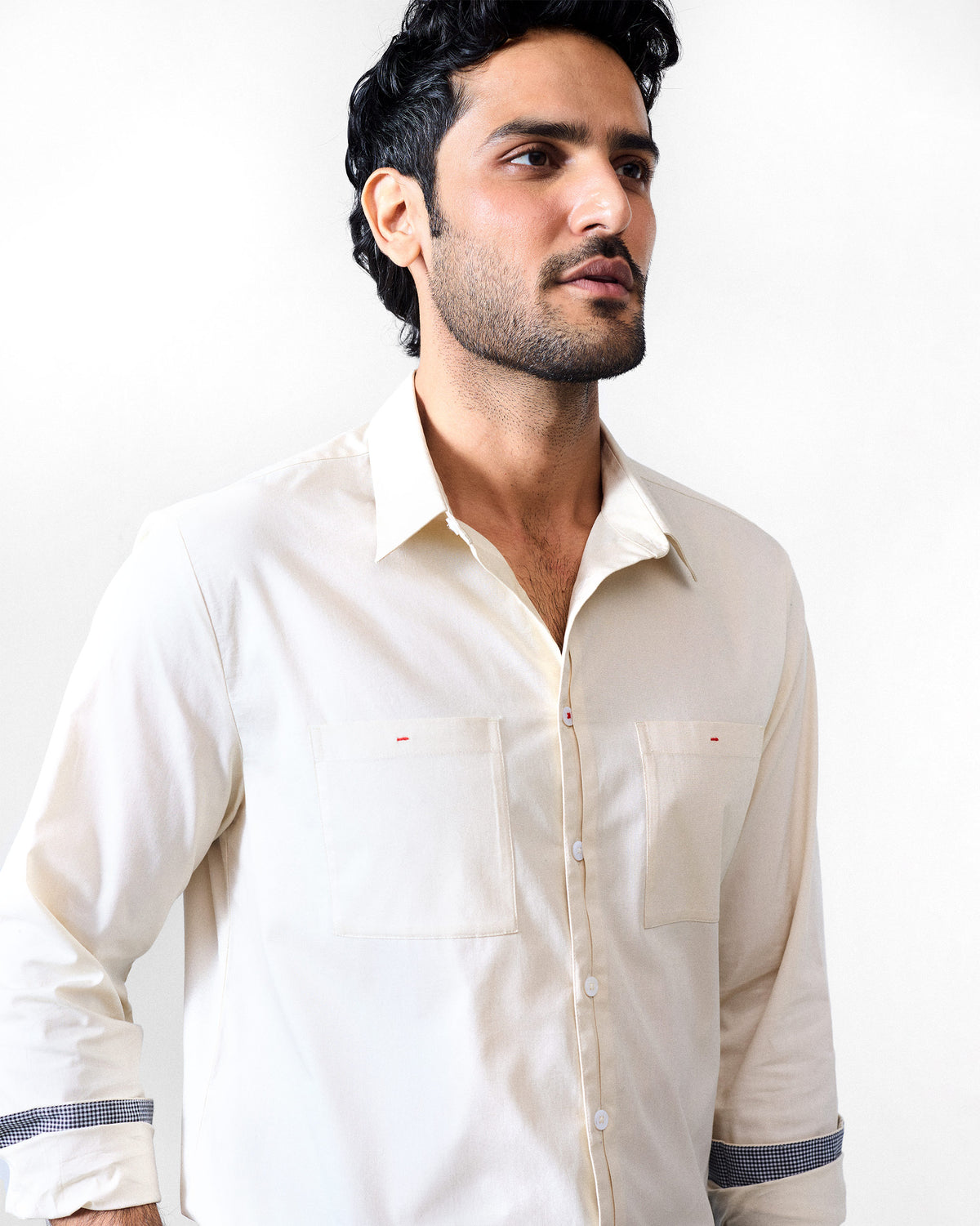 Ivory Abe shirt with red pocket accents and checked cuff lining.