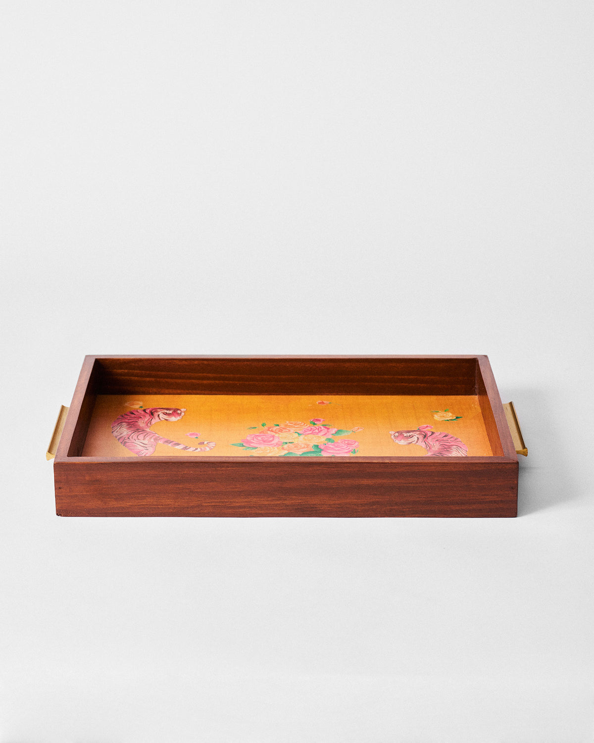 Wooden Myra tray with brass handles and pink tiger and rose print on a mustard base.
