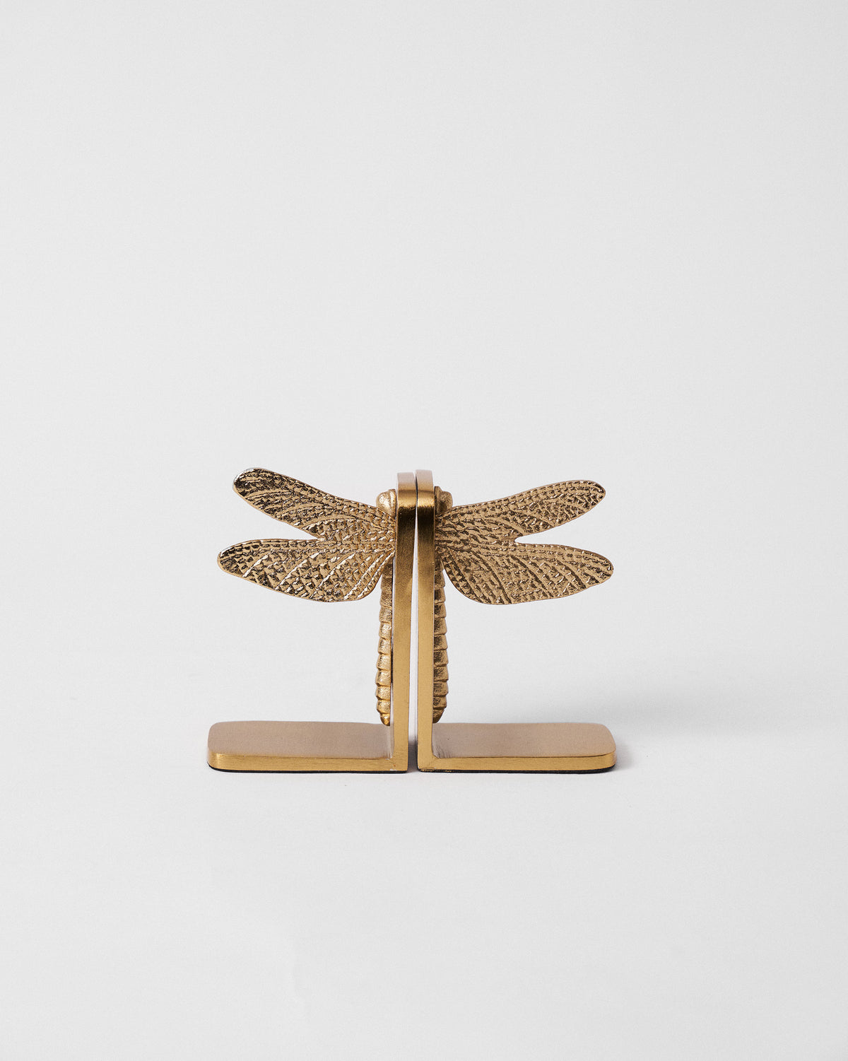 Pair of gold dragonfly bookends joined to form a full textured dragonfly.