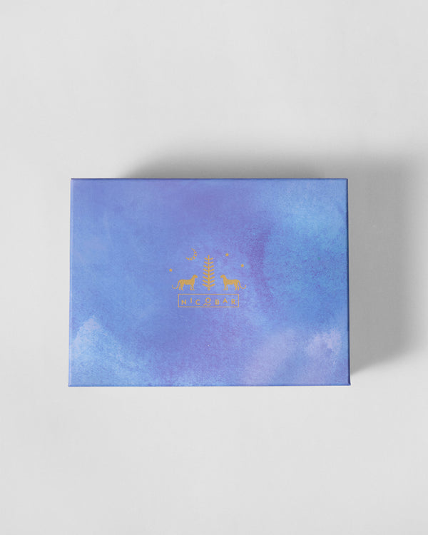 The closed lavender box with a gold crest