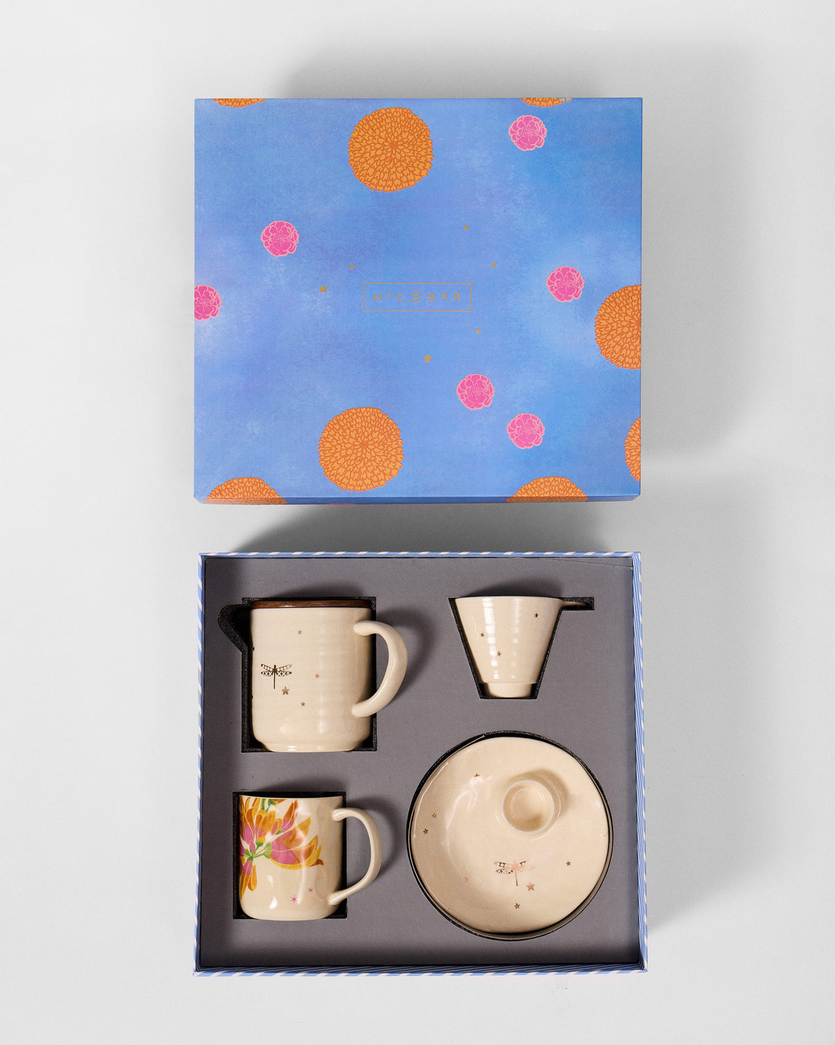 Open Aaranya gift box showing cream ceramics nestled in a grey insert.