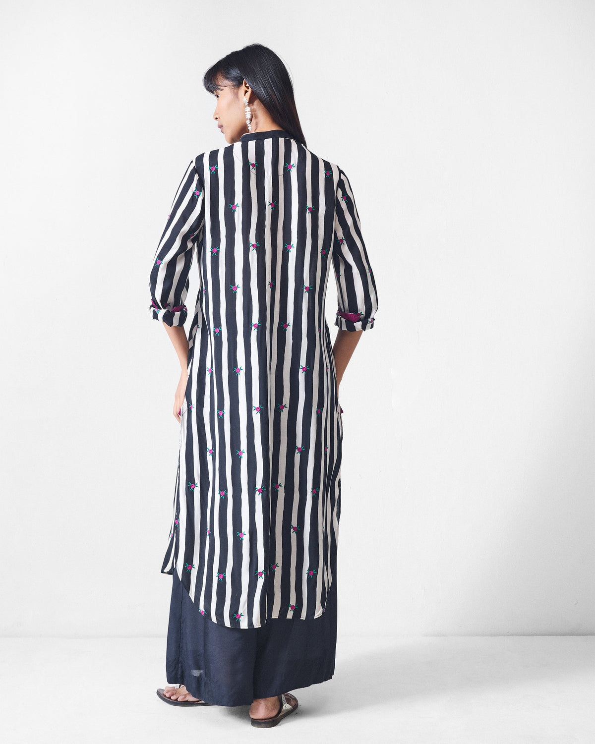 Back of a black and beige striped long kurta with pink embroidery.