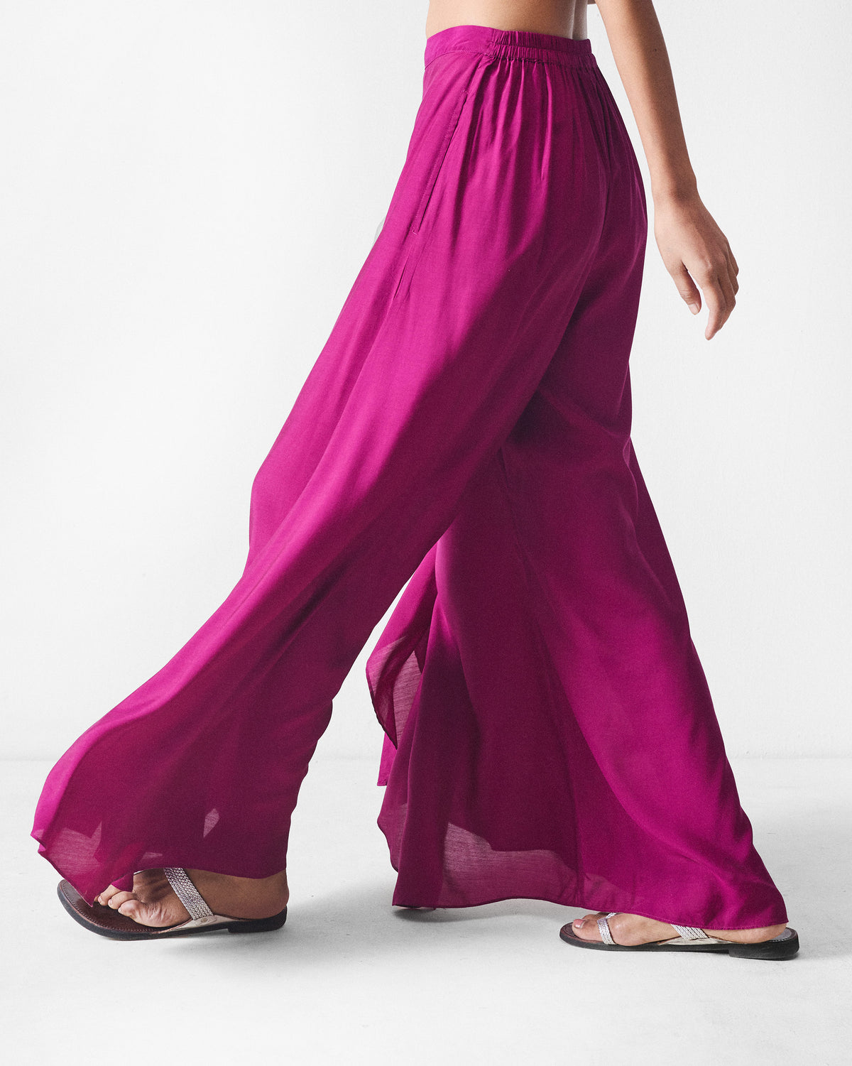 Side view of mulberry Uneven Hem pants showing the flared drape.