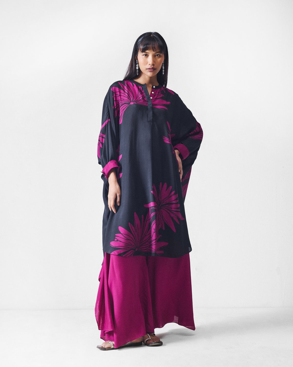 Person wearing mulberry Uneven Hem pants with a wide flared leg.