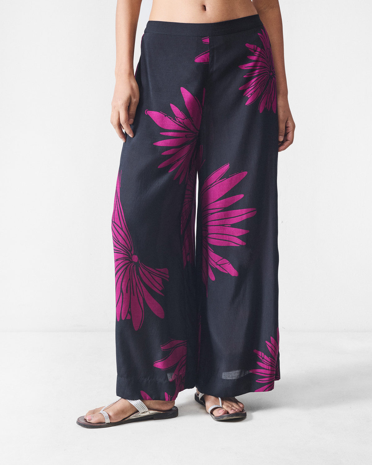 Person wearing black and mulberry printed Basic pyjamas with wide legs.